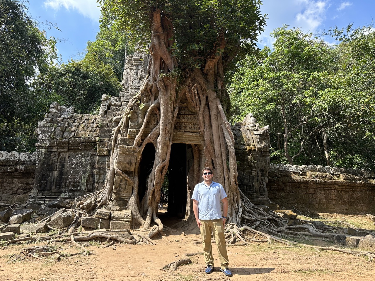 One side of Ta Som temple, overgrown with a tree