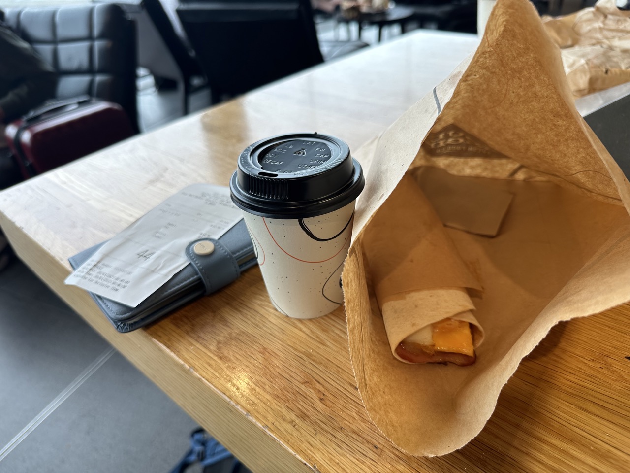 A bacon-egg wrap and small latte in Sydney Airport T2