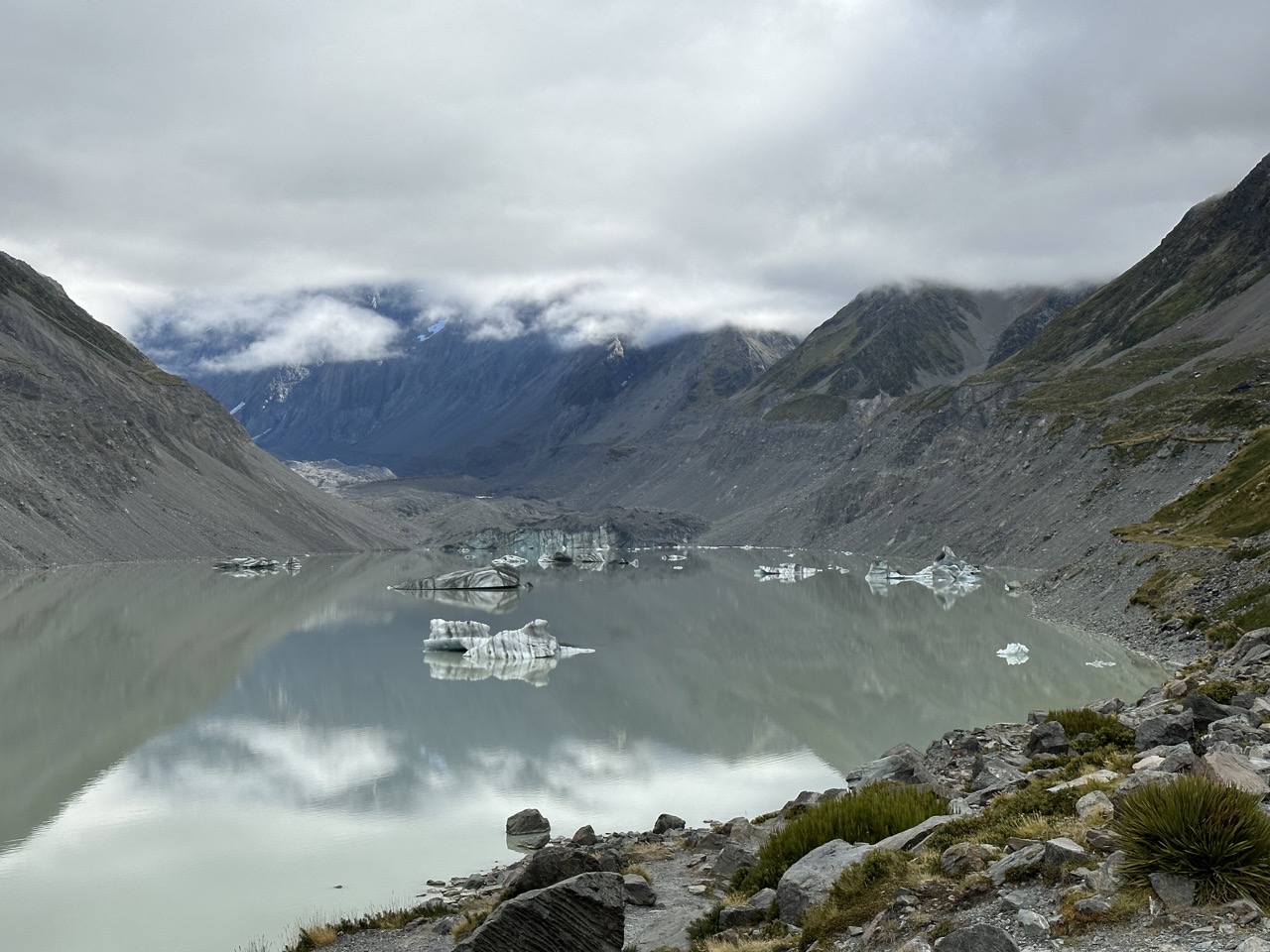 Hooker Lake, a glacier lake at the end of the track, with Aoraki in the background covered by clouds