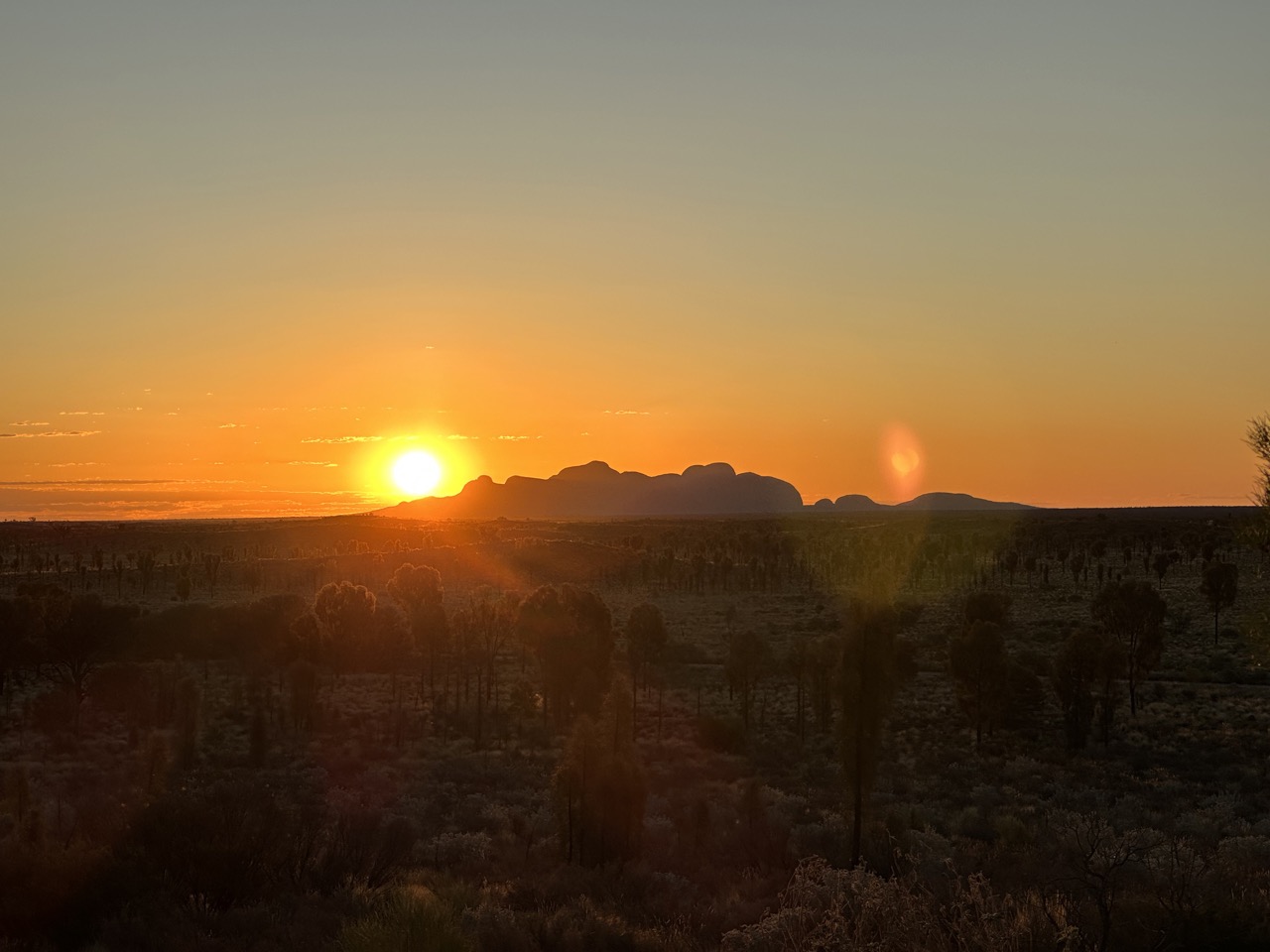 The sun setting behind Kata Tjuta