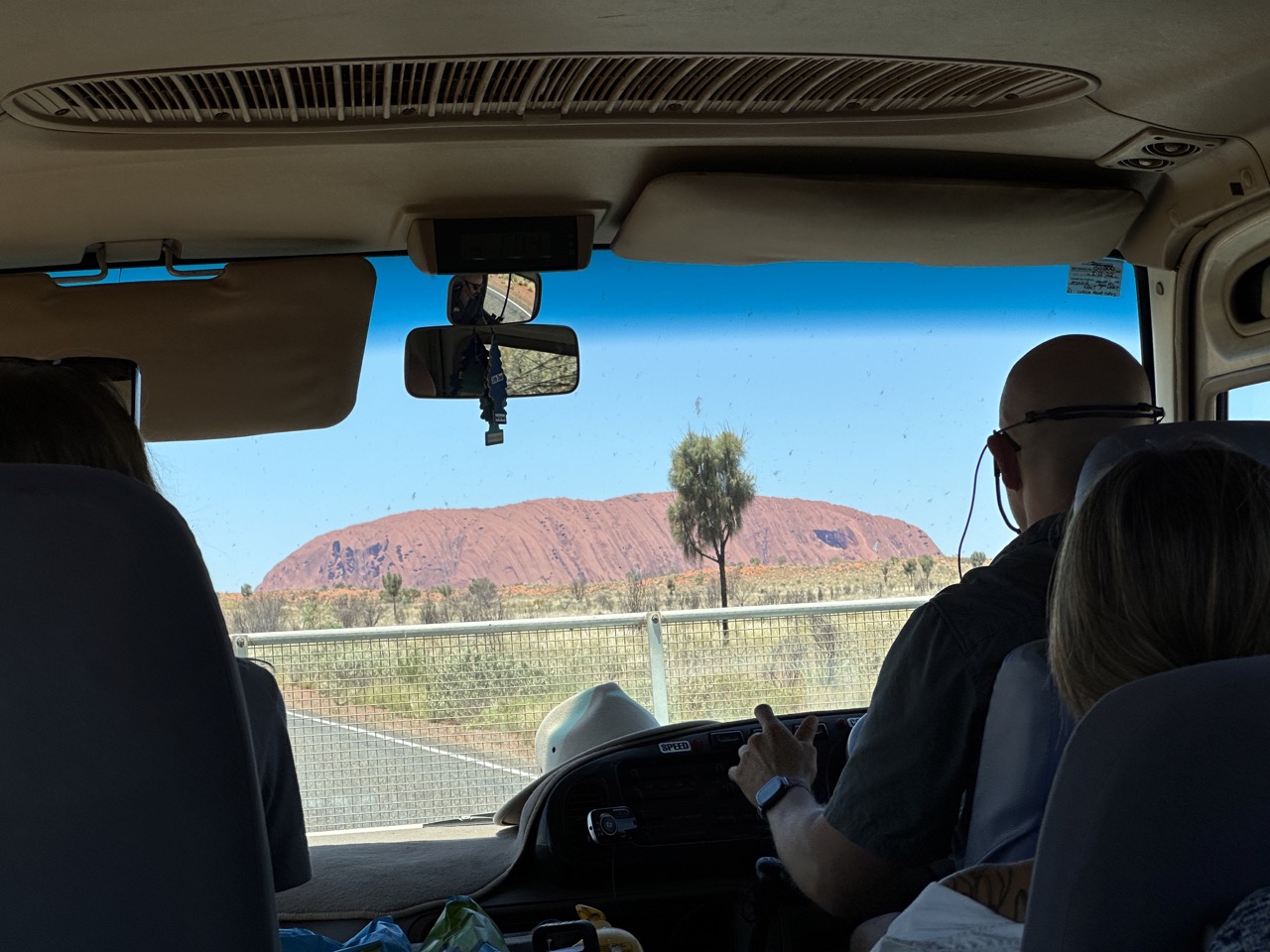 View of Uluru out the front of the bus