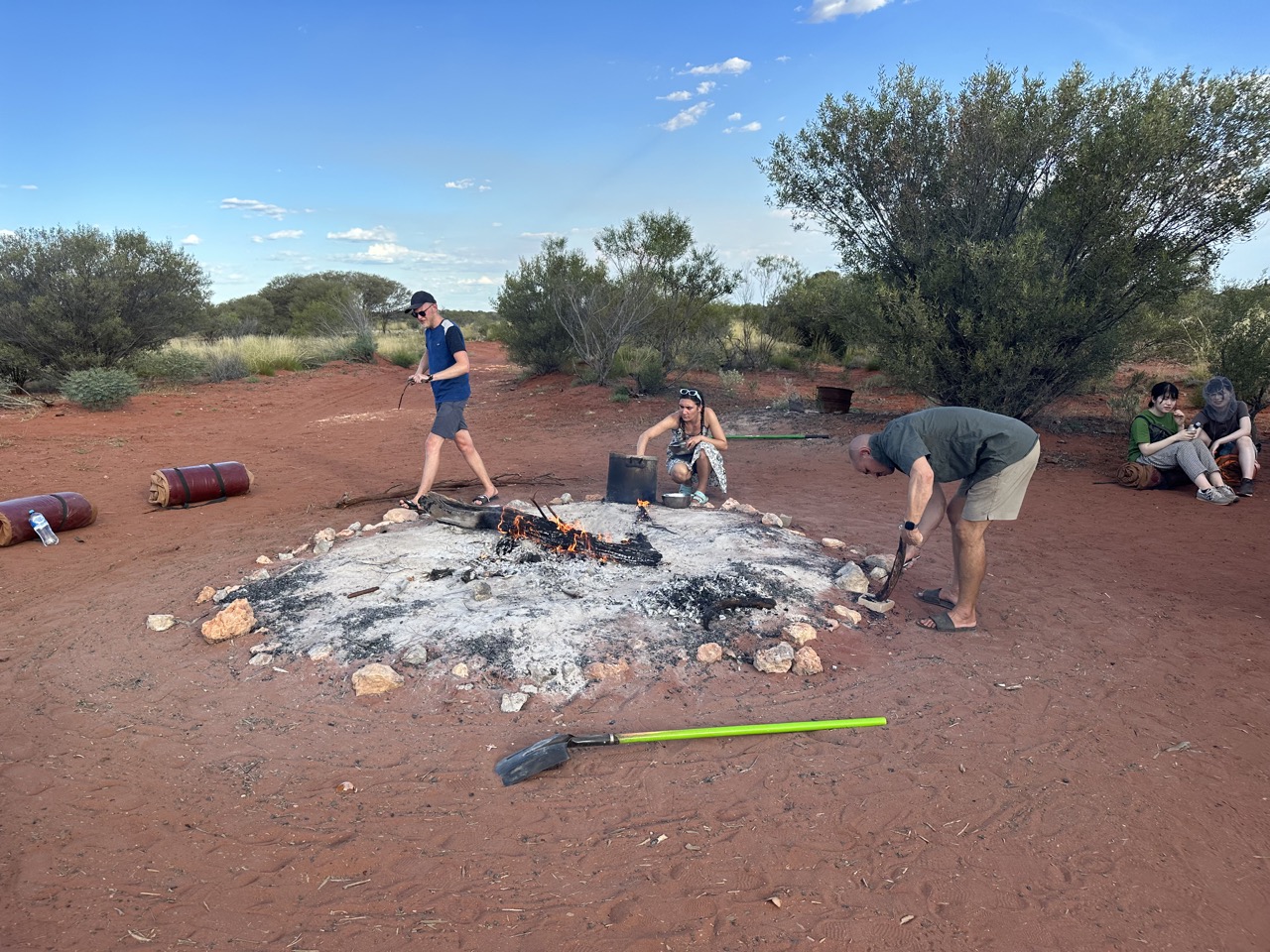 Adam messing with the kangaroo tail, Jenna making pasta, and Nils tending to the fire