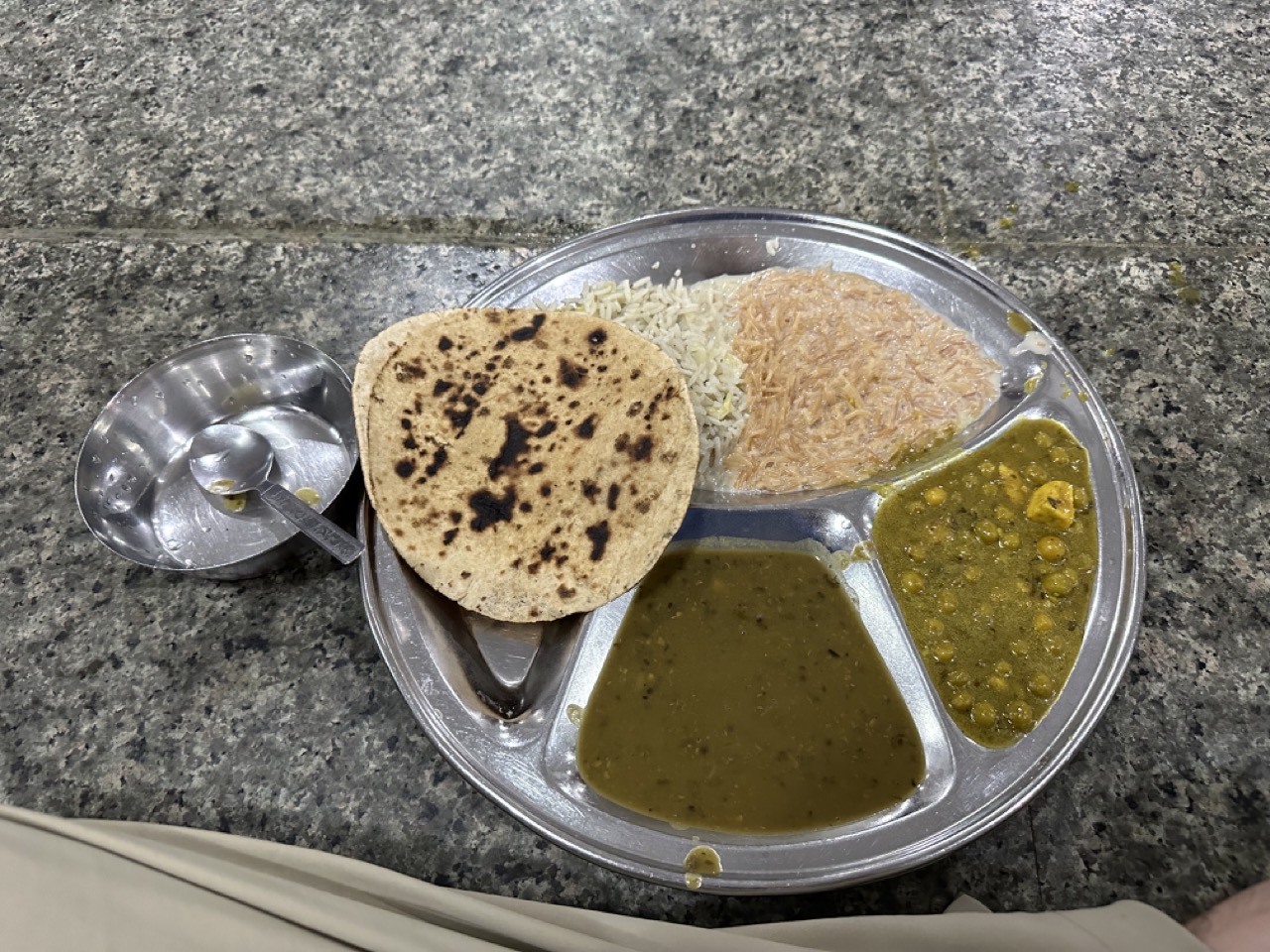 The full vegetarian meal served in the langar. I don't really know what any of it is: there is a chickpea curry, chipati, rice, dal, and seviyan kheer. The bowl is for water. You can eat until you are full