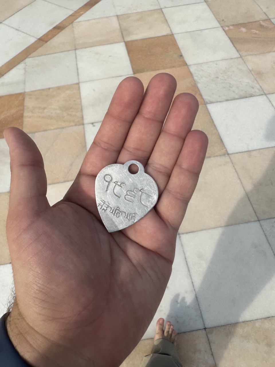 Shoes are not allowed in the temple, so you can check them, and you are given a token to retrieve them (the number is written in Gurmukhi, the script used for Punjabi language)