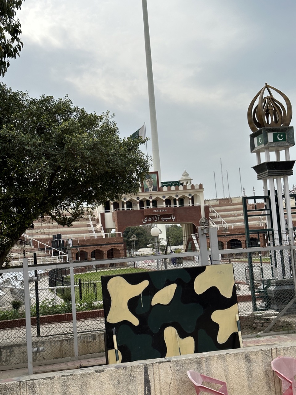 The Pakistani stadium is much smaller than the Indian stadium. There is a large portrait of Muhammad Ali Jinnah on the Pakistan side, and a larger portrait of Gandhi on the Indian side