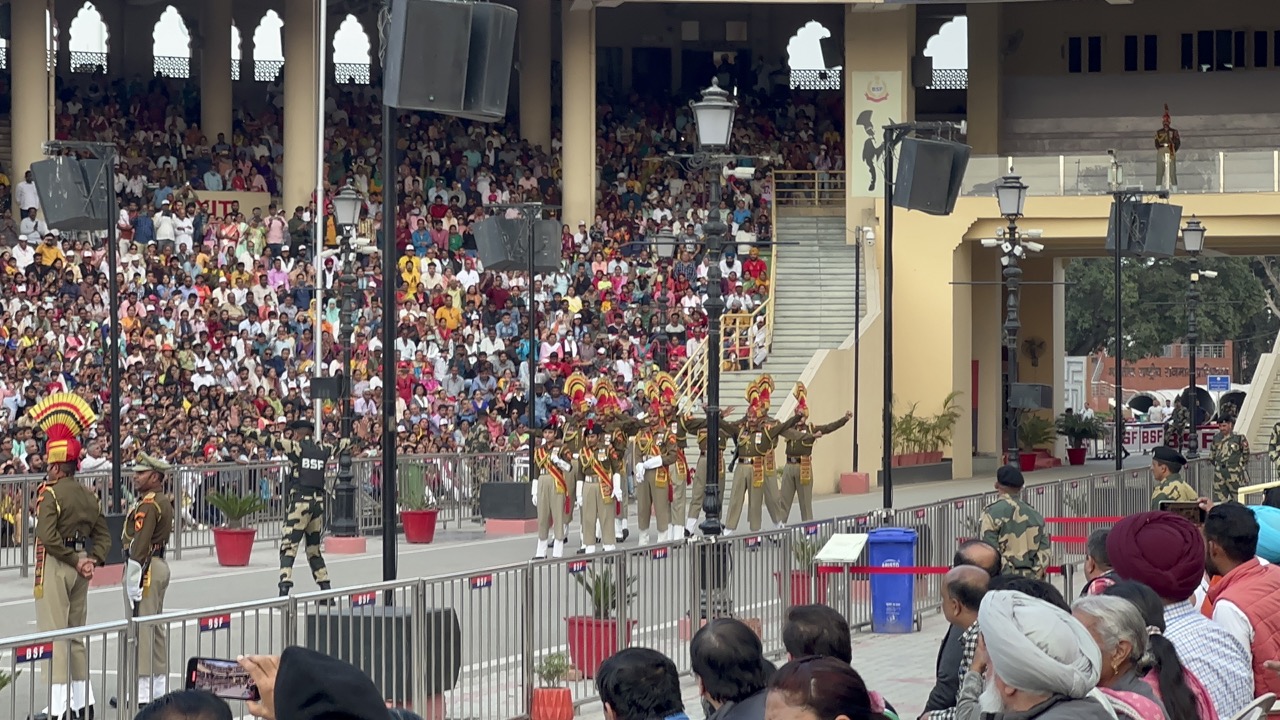 Guards wearing ceremonial uniforms with ridiculous head adornments began marching towards the border. They made crazy high leg movements as they marched