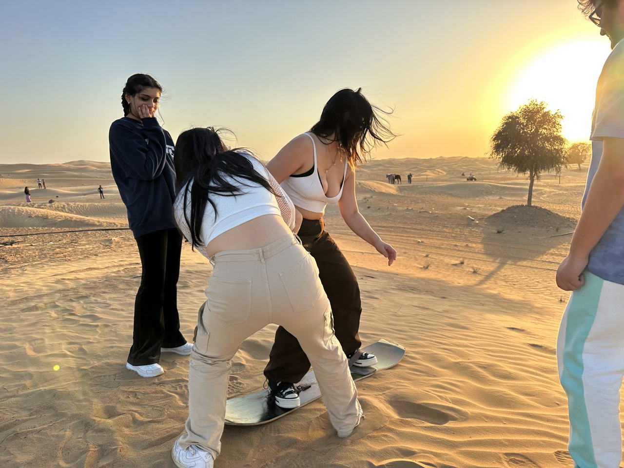 Mel tries to sandboard with assistance from Irena and Jannat